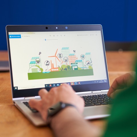 Foto eines Laptops, der die Grafik des Innovationswettbewerbs, eine futuritische Stadt, zeigt