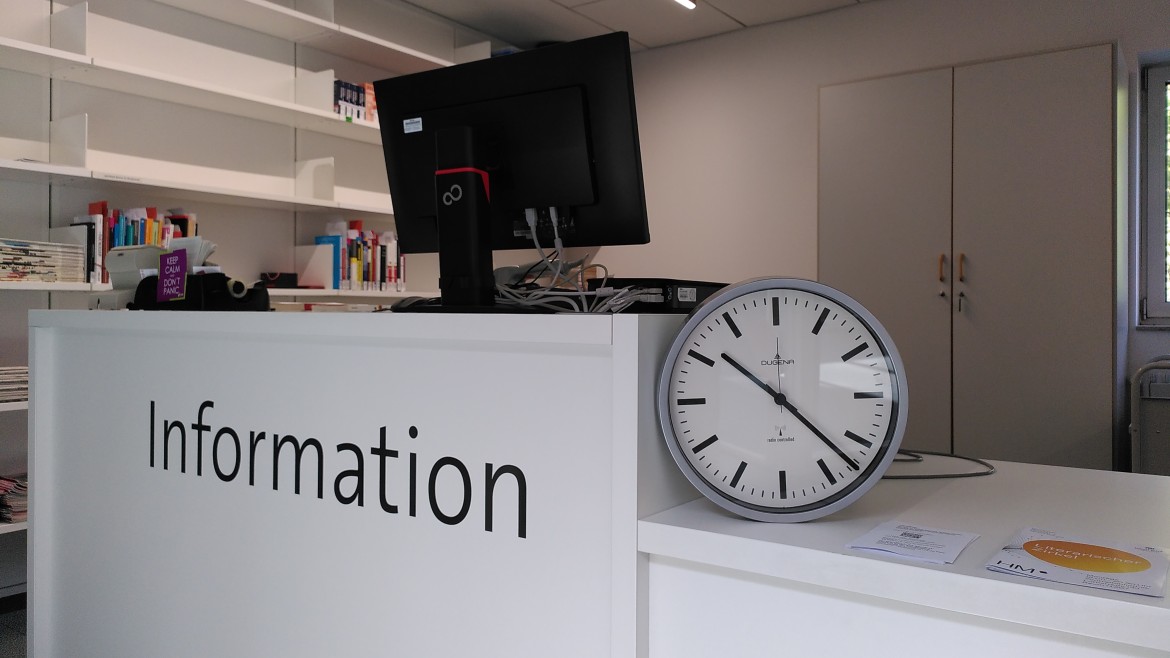 Uhr auf einer Informationstheke